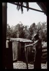 Man splitting poles. Black and white photo. 